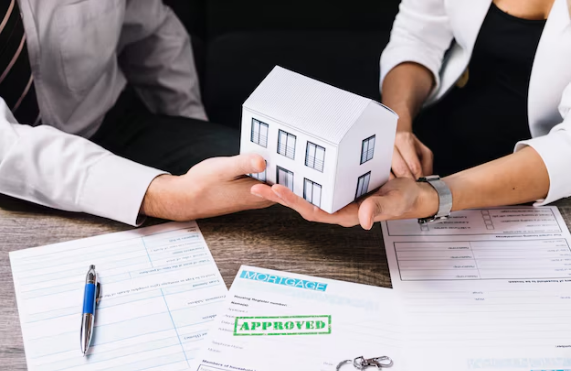 A couple holding a miniature house