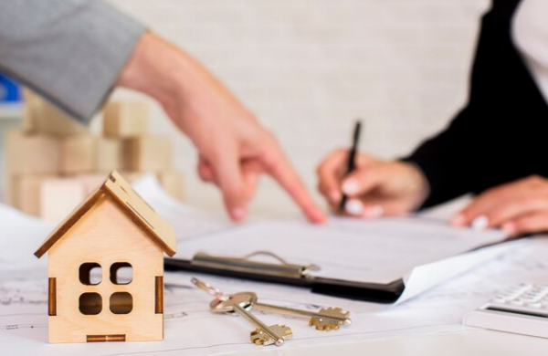 A miniature house and a set of keys