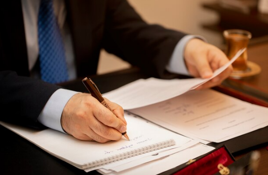 A person writing on a notepad