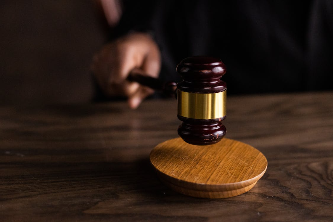 close-up of a judge using a brown gavel in a courtroom