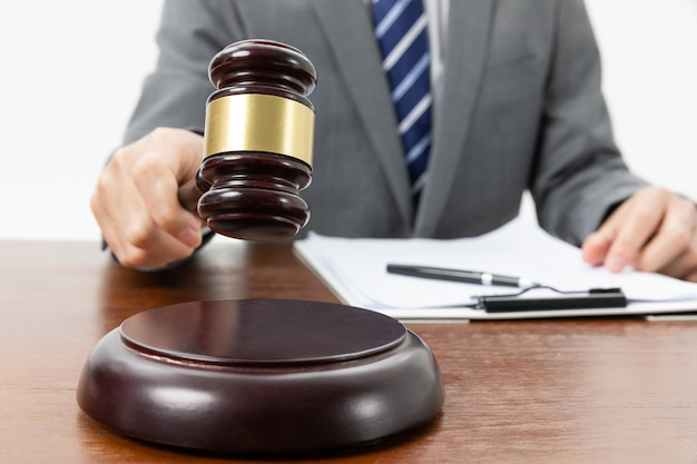A judge holding a wooden gavel