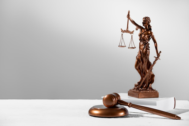 A lady of justice figurine and a wooden gavel